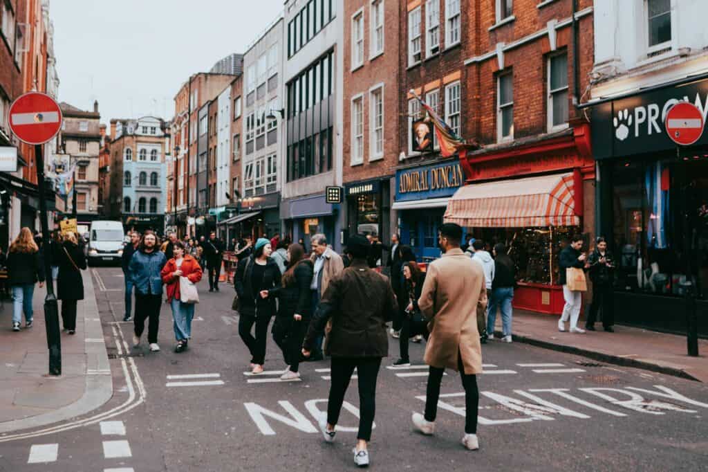 A busy street with a variety of stores and people walking