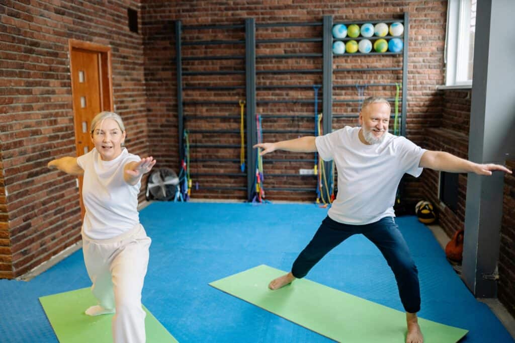 Elderly people doing yoga in a fitness centre