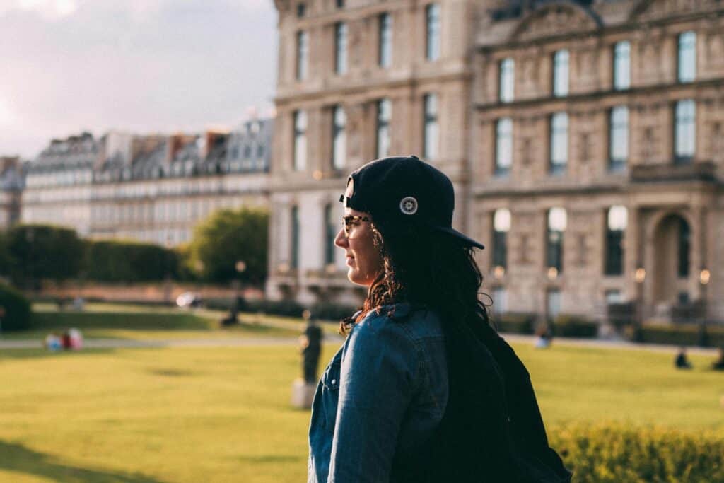 A student with the university in the background in the concept of top schools in Wandsworth.