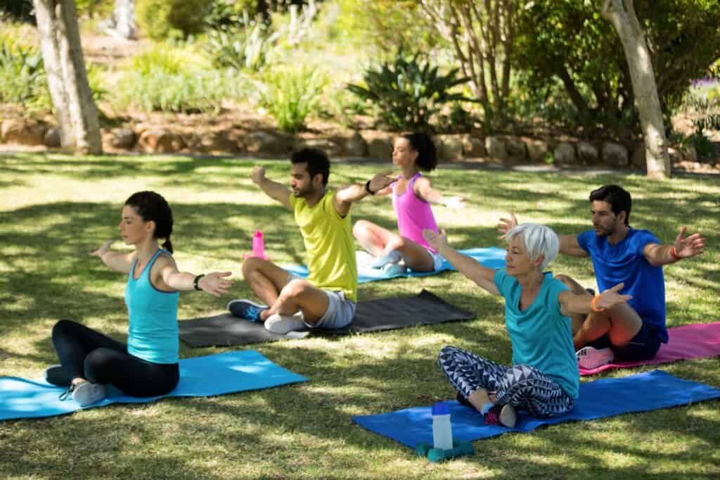 Group of people doing yoga in the park