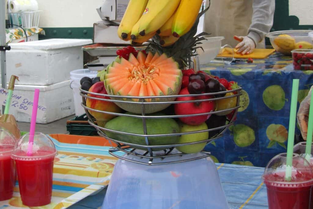 Different fruits in a juice stall in a Sunday market in the concept of 'best local shops and markets in Wandsworth'.